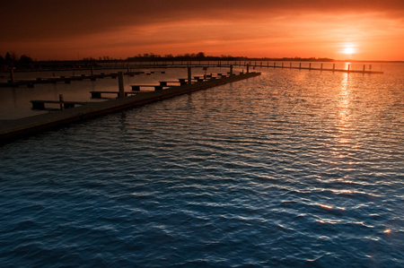 Harbor without ships at sunsetの写真素材