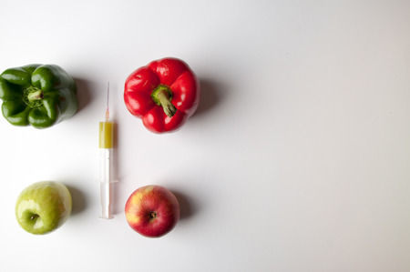Vegetables and fruits on a white background. In addition to the mask and syringe GMOの写真素材