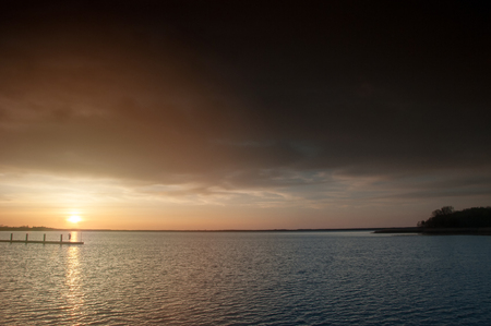 Harbor without ships at sunsetの写真素材