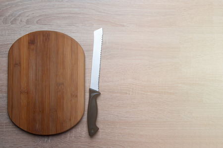 Wooden breadboard with knifeの写真素材