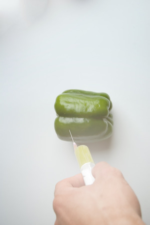 Red pepper and syringe GMOの写真素材