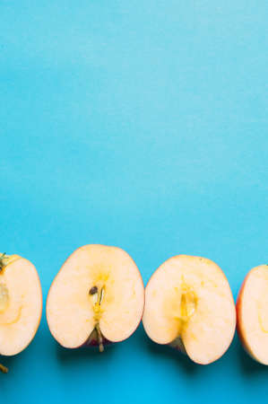 Apple halves on a blue background from aboveの写真素材