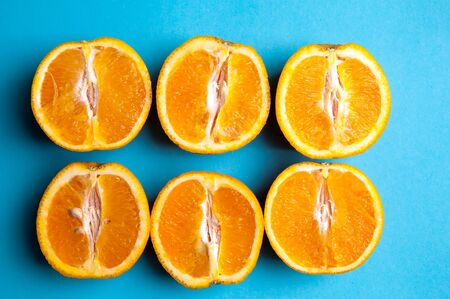Cut oranges from above on blue background