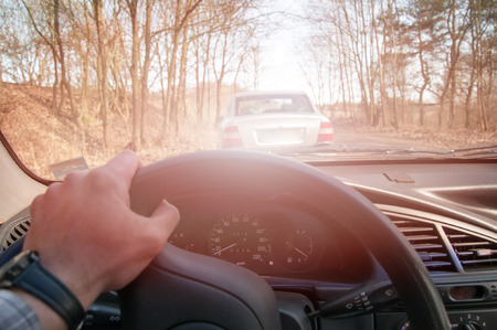 Driver's hands on the steering wheel inside of a carの写真素材