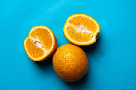 Fresh oranges isolated on a blue backgroundの写真素材