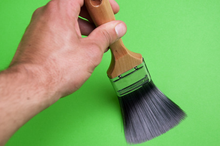 Brush and paint on a green backgroundの写真素材