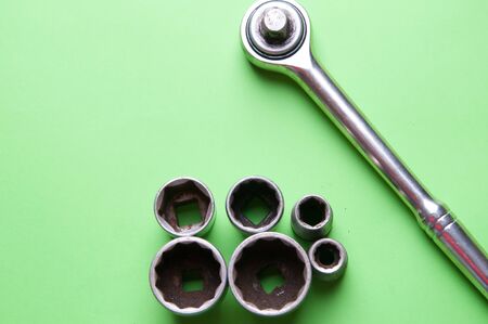 The image of tools on a green background.