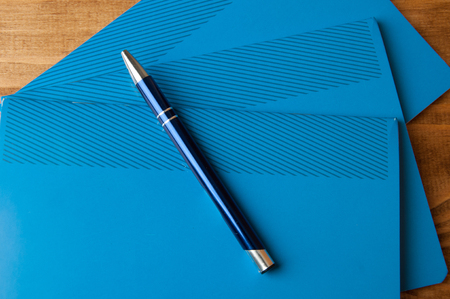 Blue school notebooks on a wooden table.の写真素材