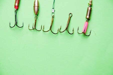 fishing hooks on a green backgound.の写真素材