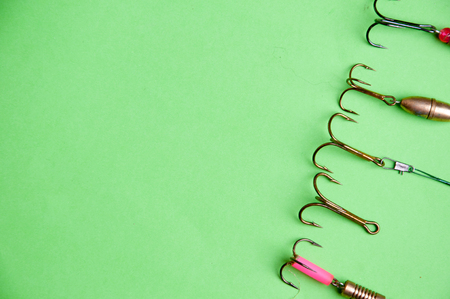 fishing hooks on a green backgound.の写真素材