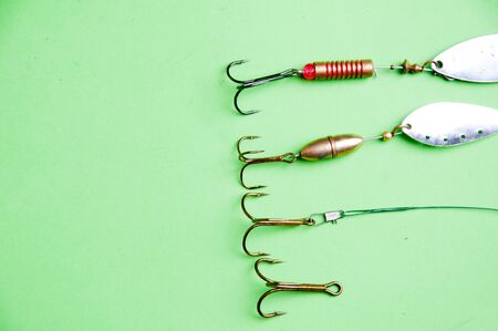 fishing hooks on a green backgound.の写真素材
