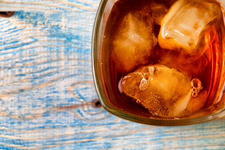 Glass of whiskey on a abstract wooden table.の写真素材