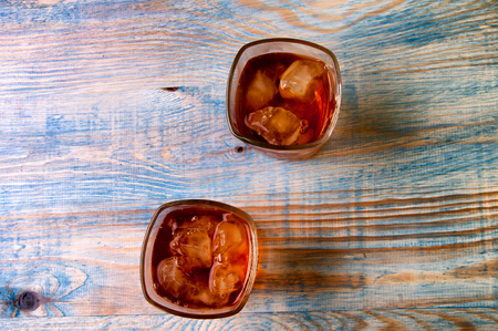 Glass of whiskey on a abstract wooden table.の写真素材