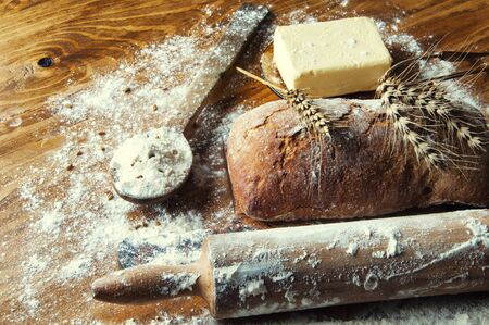 Bread and additions on a wooden table.