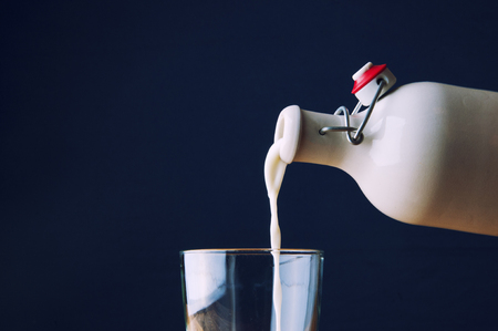 .Pouring milk into a glass.の写真素材