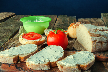 Sandwiches with cream cheese with chives wooden background.