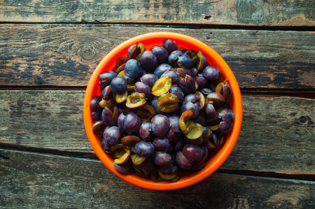 Fresh plums on wooden backgroundの写真素材