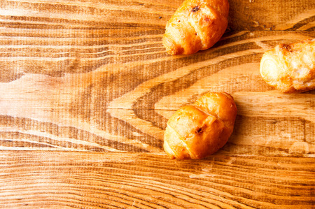 Chocolate croissants on a wooden table.