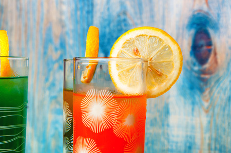 Fresh healthy fruit juices on a wooden abstract backgroundの写真素材