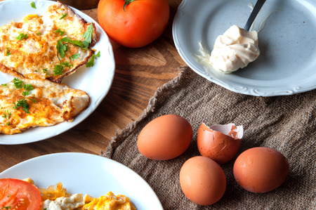 scrambled, fried, boiled eggs on a wooden table.