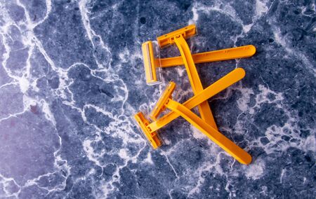 Yellow razors on a white-blue background.