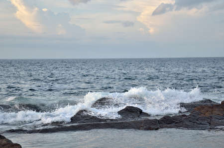 Big waves and huge water splash on rocky coast and seashoreの写真素材