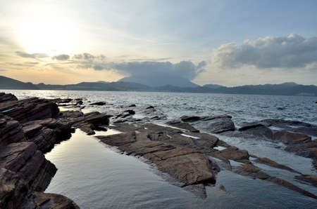 Rock in the Bay of Island under sunriseの写真素材