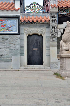 Chinese old wooden door with metal ringer knocker and wooden locker on the wallの写真素材