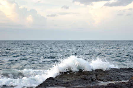 Big waves and huge water splash on rocky coast and seashoreの写真素材