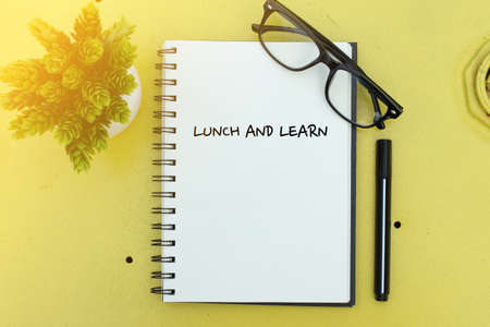 Business concept. Notebook writing Lunch and Learnの写真素材