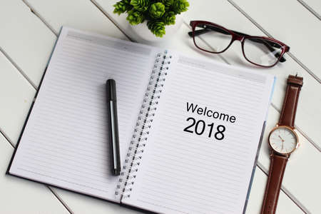 Top view notebook writing Welcome 2018