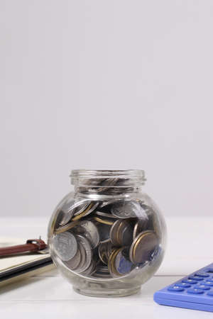 coin in glass jarの写真素材