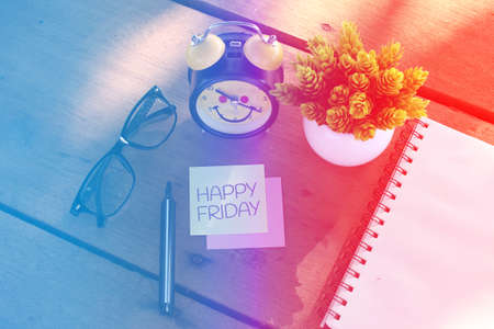 Happy Friday writing on note paperの写真素材