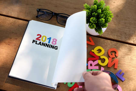 2018 Planning concept with notebook on wooden tableの写真素材