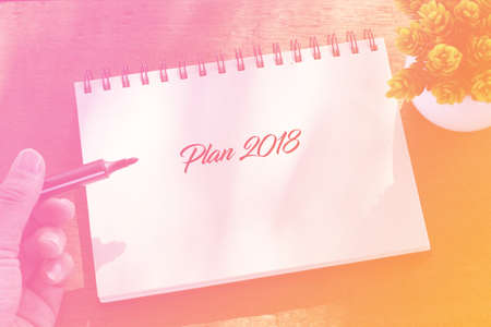 Plan 2018 writing on notebook with duotone concept