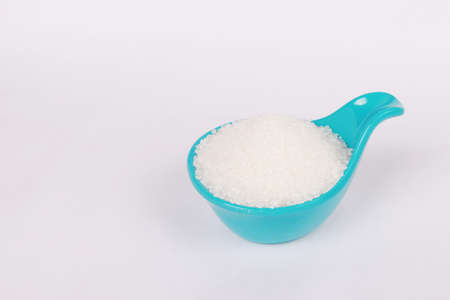 sugar in green plastic container isolated on white backgroundの写真素材