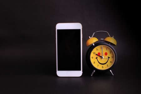 time management concept. smartphone and analog clock
