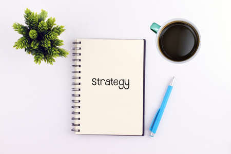 Strategy writing on notebook with pen and coffeeの写真素材