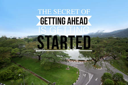 Inspirational success motivation quotes on lake and mountain view as a background. The secret of getting ahead is getting startedの写真素材