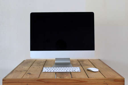 Side view computer desktop and coffee cup on desk work in coffee shop