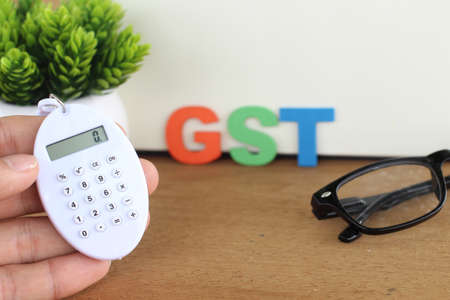 Word of GST spelled with colorful wooden alphabet blocks.Selective focus,shallow depth of fieldの写真素材