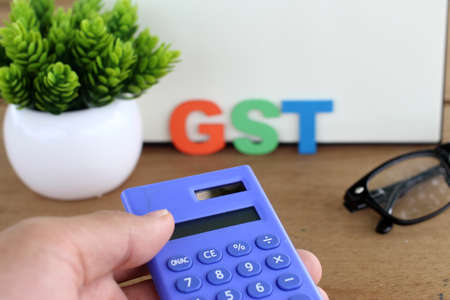 Word of GST spelled with colorful wooden alphabet blocks.Selective focus,shallow depth of fieldの写真素材
