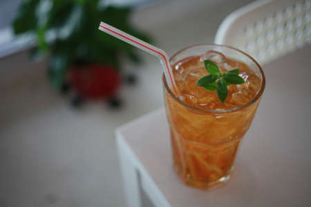 Hand hold a ice lemon tea on cafe backgroundの写真素材