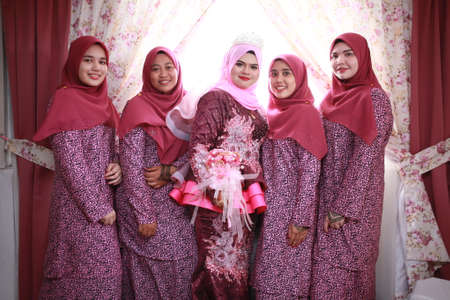 KANGAR,PERLIS,MALAYSIA. 10th April 2019: Bride with beautiful bridesmaids in pink dresses holding...