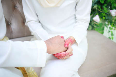 Romantic wedding couple holding hand. muslim wedding ceremony. solemnizationの写真素材
