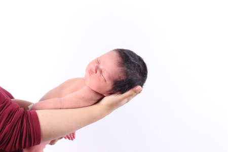Asian mother is holding her sleeping newborn baby