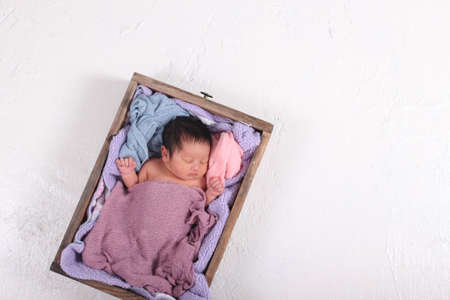 Cute newborn asian boy sleepingの写真素材