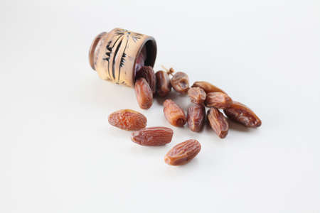 ramadan concept. rosary with date and hol quran isolated on white background.の写真素材