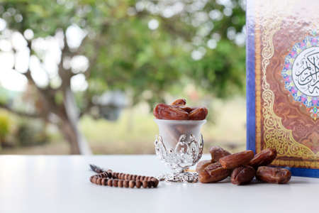 Ramadan concept with nature background, holy quran, date fruit and rosary