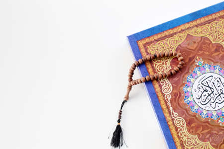 holy quran and rosary isolated on white background